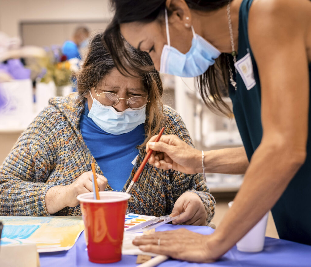 patient and teacher in art workshop